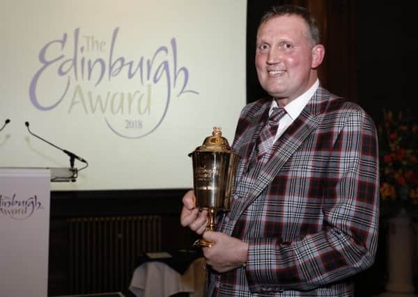 Donning a suit made of the official City of Edinburgh tartan, which he had made especially for the occasion, rugby legend and charity campaigner Doddie Weir receives the City of Edinburgh Award 2018. Photograph: City of Edinburgh Council