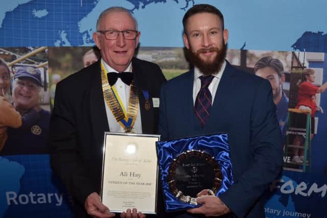 Ali Hay receiving the first of this week's awards from Rotarian im Mackie.