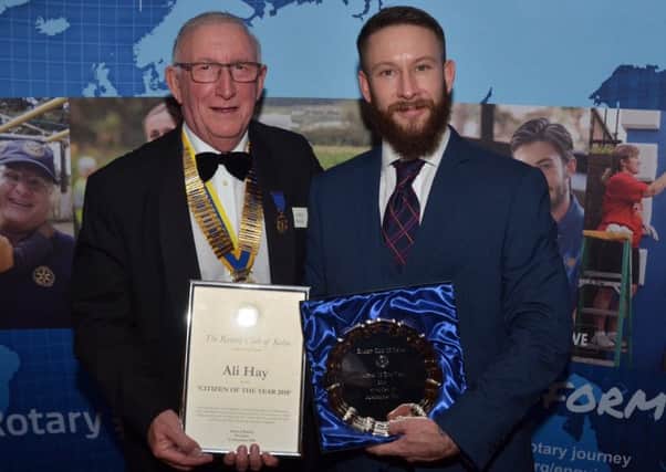 Ali Hay received his Citizen of the Year award from Kelso Rotary Club president  James Mackie.