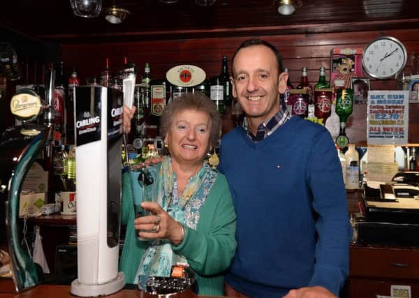 Niki  Fitzgerald, with her son and business partner Norman MacIver, behind the bar at Nikis in Galashiels.