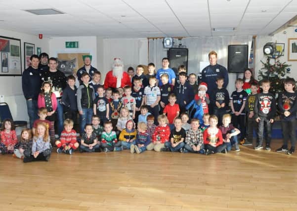 Santa, The Rhino and first XV squad members with the young Selkirk rugby devotees.