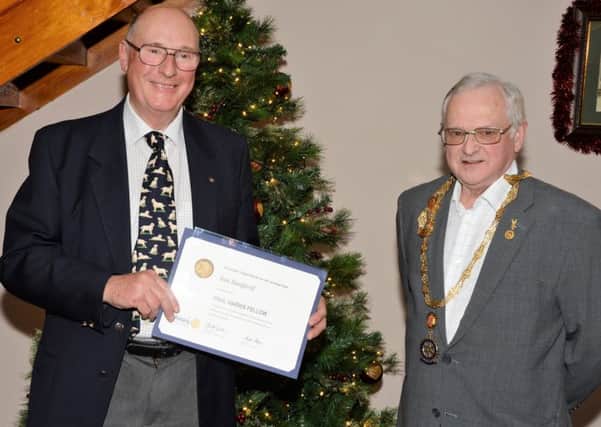 Jedburgh Rotarian Ian Sanford receives the organisations Paul Harris Award from club president Eddie Muir at the towns Carters Rest.