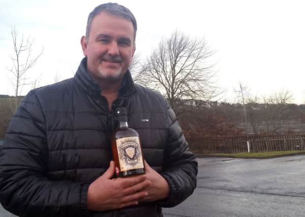 Allan Walker with a bottle of Selkirk Distillers' bannock gin.