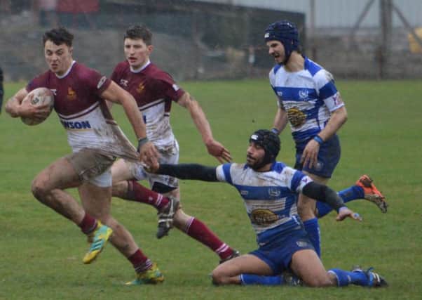 Gala YM try to make the break away from blue and white-striped Leith (picture by Brian Gould).
