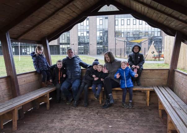 Janie and Jack Brown with dad Chris, left, while Joseph, Luke, Enya and Liam flank mum Nicola Kelly in the schools new hut.