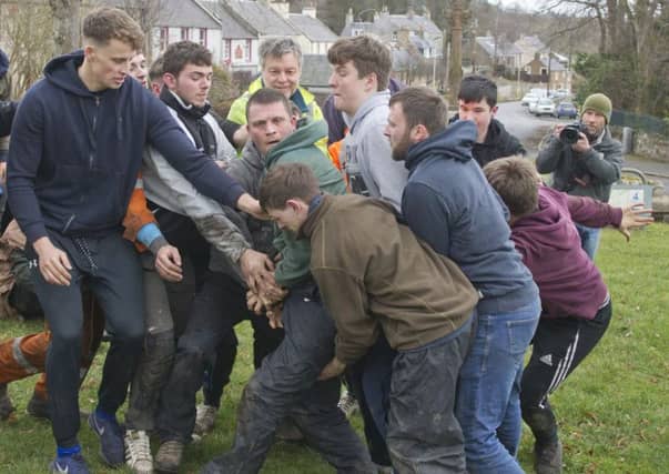 Robbie Elder, Craig Cowan and Craig Goodfellow grapple for the ba' at Ancrum.