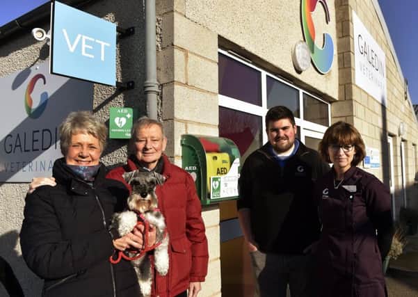 Jacky and Hamish Ritchie, with their dog Penny, vet Robbie Norquary and receptionist Sheila Fleming.