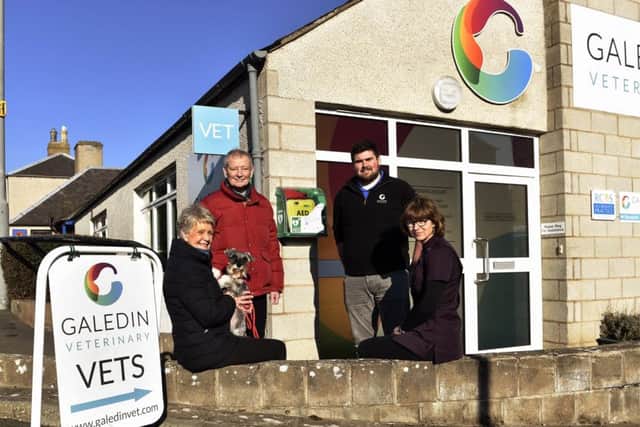 Jacky and Hamish Ritchie, with their dog Penny, Galedin Vets vet Robbie Norquary and receptionist Sheila Fleming.