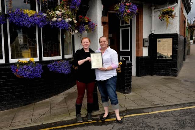 Nikki Cassidy, left, is presented with the pub's 2017 award by Sarah Bellis.