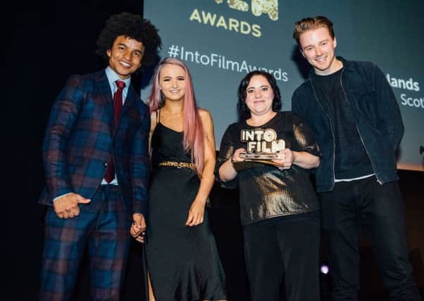 LONDON, ENGLAND - MARCH 04: Jack Lowden (R) presents Into Film Club of the Year: Secondary Award, sponsored by Warner Bros. Creative Talent, 'Rowlands' Selkirk, Scotland at the Into Film Awards at Odeon Luxe Leicester Square on March 04, 2019 in London, England.   Pic Credit: Dave Benett