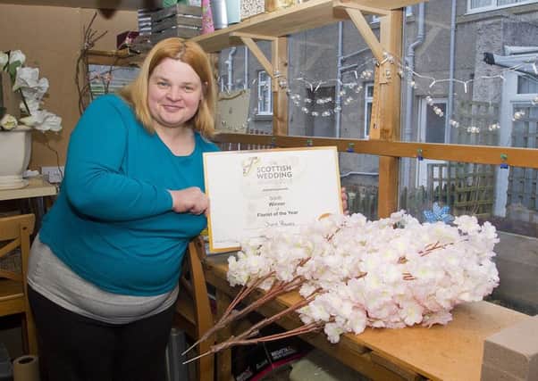 Christine Hannay of Scents florist, Galashiels, with her certificate from the Scottish Wedding Awards.