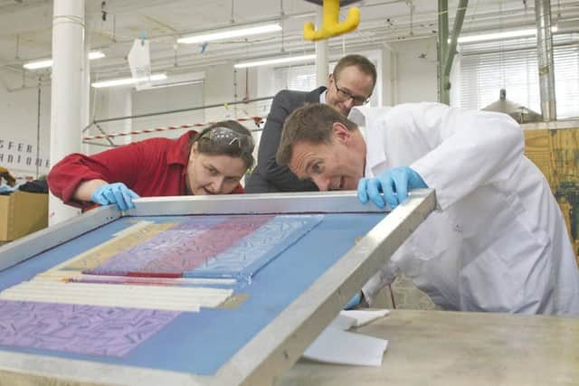 Screen printing technician Grace Smith with Jeremy and John Lamont