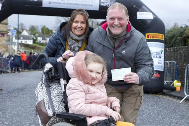 Steven and June Russell with their daughter Maia from Ancrum. The Rally presented a cheque for £250 towards a new wheelchair for Maia, this brought them to the threshold of £5000 for the new wheelchair.