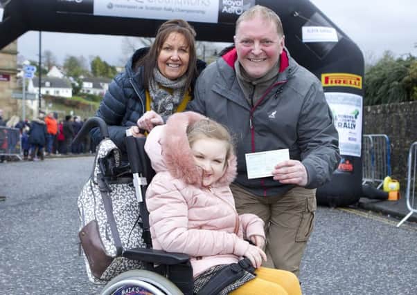 Steven and June Russell with their daughter Maia from Ancrum. The Rally presented a cheque for £250 towards a new wheelchair for Maia, this brought them to the threshold of £5000 for the new wheelchair.