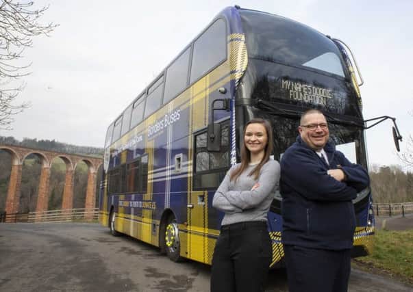 Lee Young and Julianne Smith with Borders Buses' Doddie Weir bus.