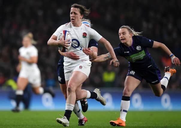Katy Daley-Mclean of England breaks away from Scotland's Border duo of Lana Skeldon (hidden) and Chloe Rollie at Twickenham on Saturday (photo by Shaun Botterill/Getty Images).