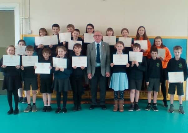 Kelso Rotary Club president Jim Mackie with Morebattle primary school pupils who entered the clubs Young Writers Competition.