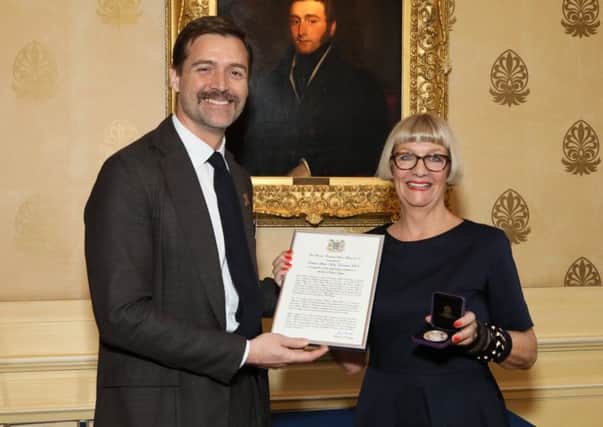 Telly design judge Dr Patrick Grant awards Professor Sheila-Mary Carruthers her silver medal.