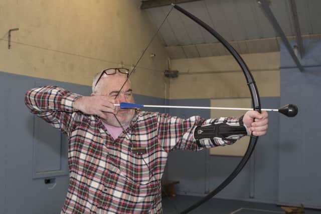 Reporter Kevin Janiak tries his hand at Battlezone archery.