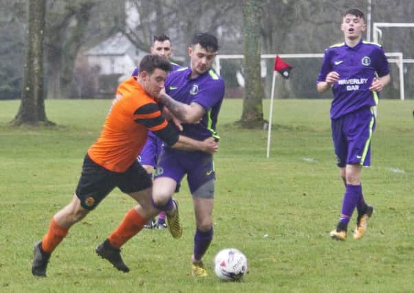 Dean McColm, in purple, one of Waverley's goalscorers, fends off a challenge during a derby match earlier in the season against Hawick United (library image).