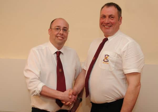 Darren Miller is congratulated on his appointment by Weavers deacon Mick Quinn.