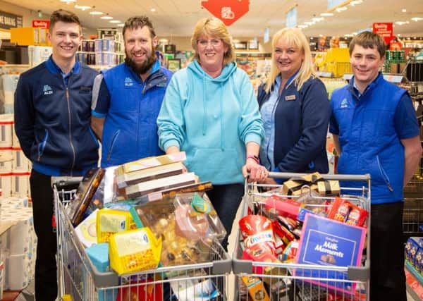 Supermarket sweep winner Caroline Stillie with staff at Aldi in Hawick.