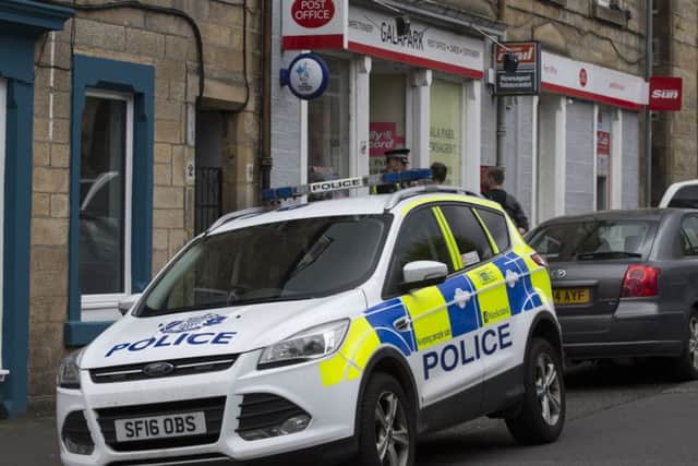 Police outside the Galapark Post Office in Galashiels after yesterday's robbery.