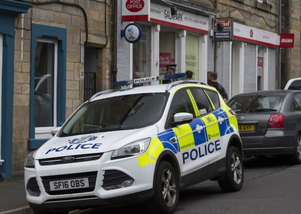 Police outside the Galapark Post Office in Galashiels after yesterday's robbery.