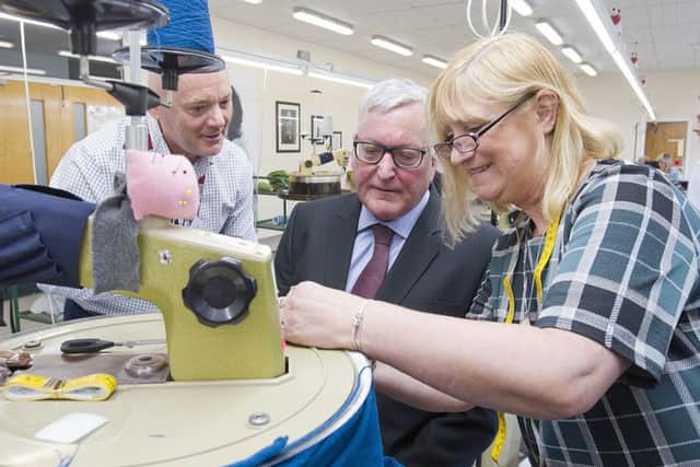 Fergus Ewing, the Scottish Government's rural economy secretary, having a go at body-linking with centre manager Alistair Young and tutor Myra Murphy.