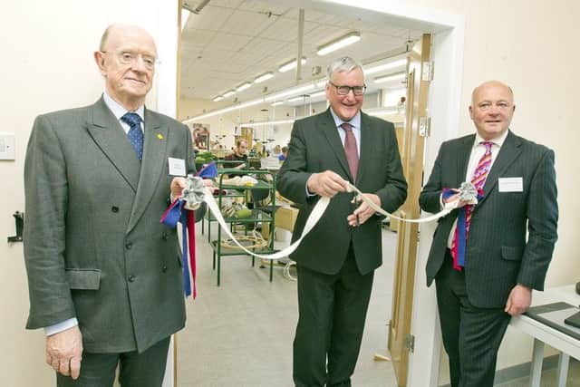 South of Scotland Economic Partnership chairman Russel Griggs, left, and councillor Mark Rowley, right, help Holyrood rural economy secretary Fergus Ewing officially open Hawick's new textile training centre.