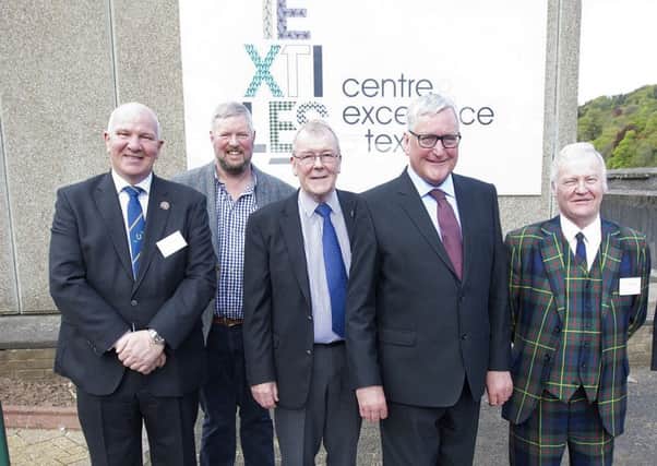 Hawick councillors, from left, Watson McAteer, Neil Richards, George Turnbull and Davie Paterson at Hawick's textile centre of excellence with, fourth from left, Fergus Ewing, Scotland's rural economy secretary.