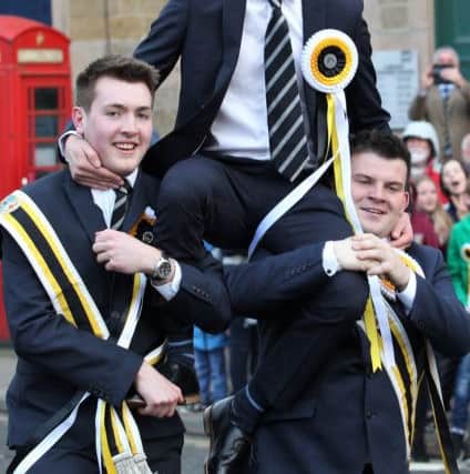 Melrosian for 2019, Ben Magowan, flanked by his right and left hand men, Harry Fletcher and Russell Mackay, who carried him three times round the Mercat Cross, as tradition dictates.