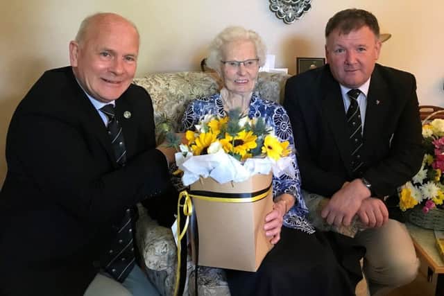 Melrose RFC president Douglas Hardie and Sevens secretary Gordon Chisholm with Kathleen Dun.