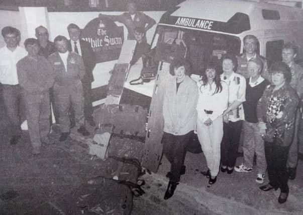 Kelso's White Swan pub makes a donation to the ambulance service in 1994.