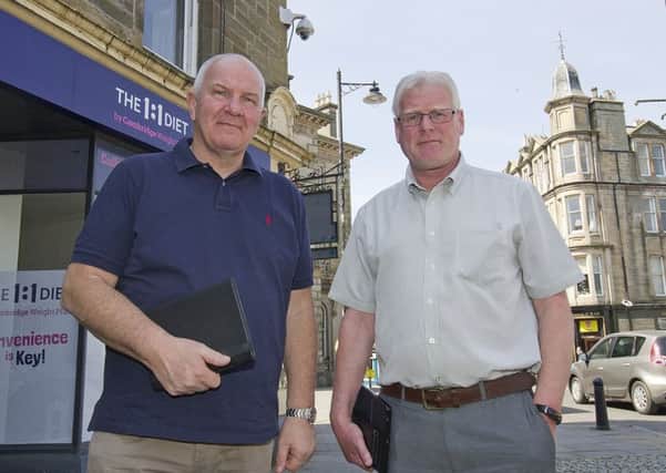 Councillors Watson McAteer and Stuart Marshall inspecting Hawick's CCTV system.