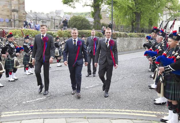 Callant Euan Munro flanked by Nick Arnold, Brodie Irvine and herald Rob Reid march  through a guard of honour to the town hall reception.