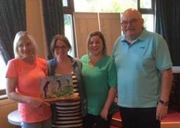 Pictured, from left, is the winner, Anne Allan, with the Rafferty family, Yvonne, Kirsten and Bennie.