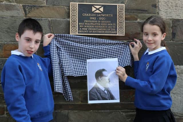 Charles Lapworth's plaque being unveiled in Galashiels by Matthew Coull and Chloe Thomson, both pupils at St Peter's Primary School.