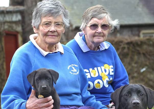 Betty, left, and Alison pictured with their training dogs in 2008.