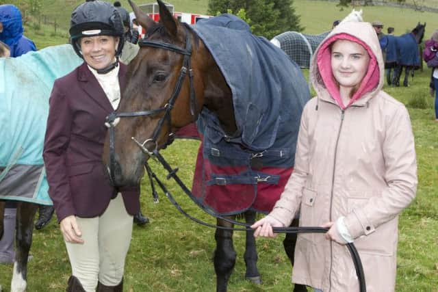 Dance teacher Sam Deans with Ellen Dobbie tending to her horse in the break at Mosspaul.