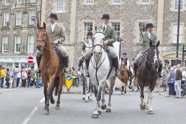 Supporters line the streets in Hawick to wave to the cavalcade.