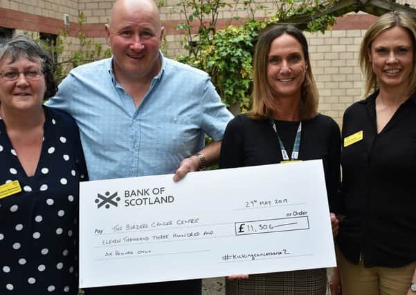 Kenny Houston hands over the cheque for £11,306 to Rachel Johnson, watched by Christine Henderson (on left), colorectal clinical nurse specialist, and Lynda Taylor (on right), nurse consultant in cancer.