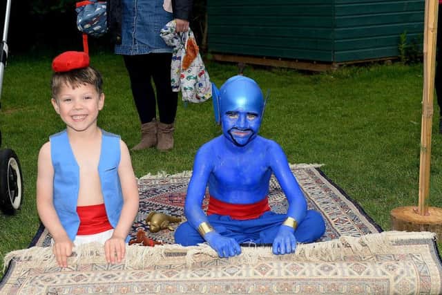 Alladin and the genie take a trip on their magic carpet.