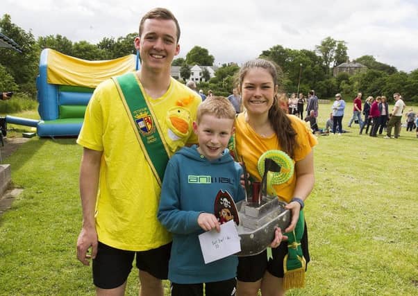 Principals Stefan Cameron and Emma Wauchope with Max Lee and his winning boat.