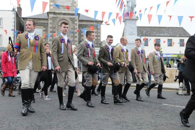 Burleymen and attendants join the standard bearer on the way to the First Drum.