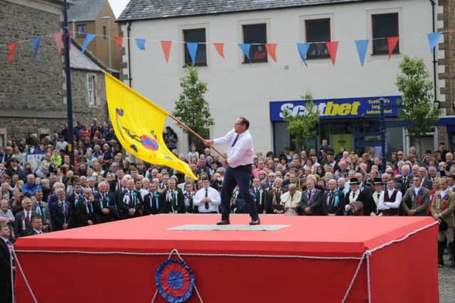 Colonials Standard Bearer Stuart Smith casts the flag
