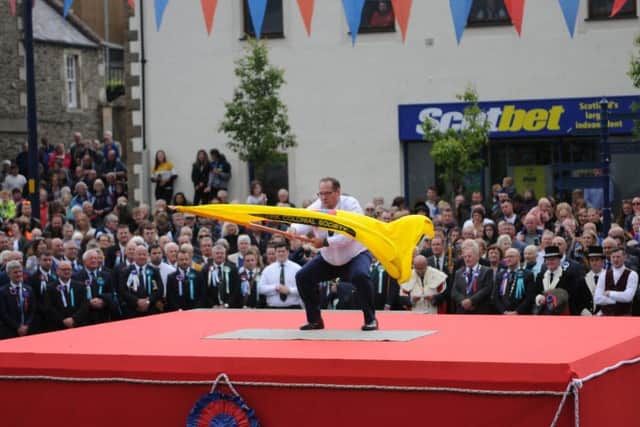 Colonials Standard Bearer Stuart Smith casts the flag