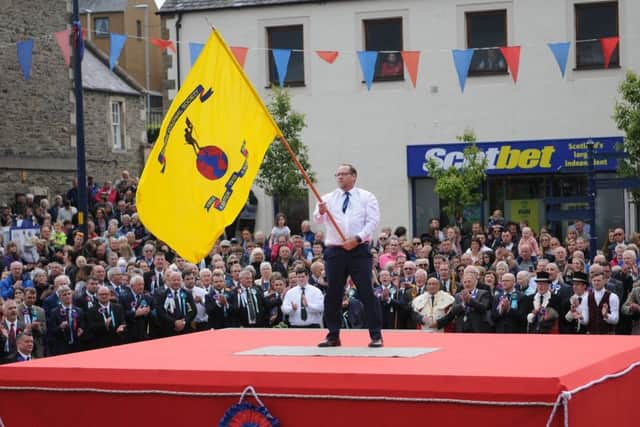Colonials Standard Bearer Stuart Smith casts the flag