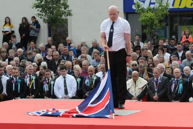 Ex-Soldiers standard bearer Justin Gilchrist dips the flag.