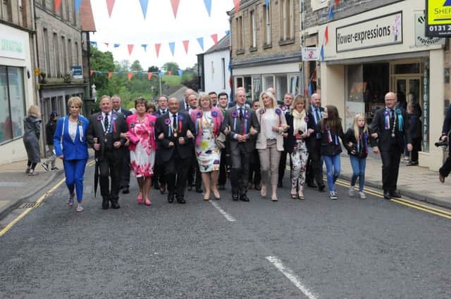Members of the Common Riding Trust and Craig Monks' parents Keith and Iona lead the procession round the town.